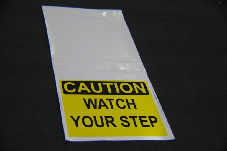 CAUTION - Watch your step hanging sign